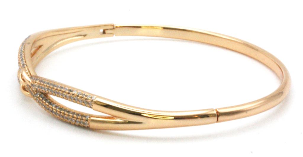Women's bangle. This is an elegant bracelet in rose gold plating over stainless steel. The face shows a buckle design and is pave set with clear zircon gemstones. side view