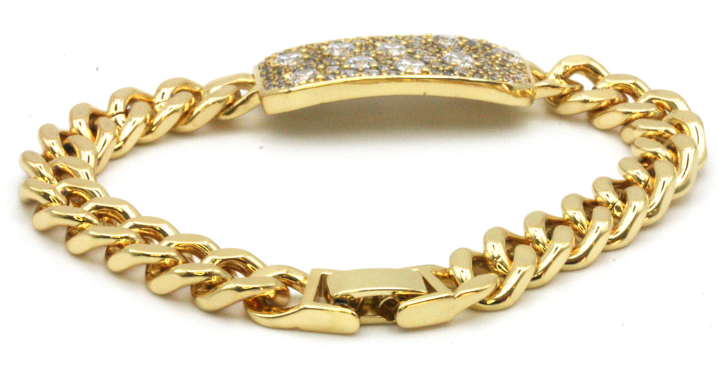 Women's bracelet. Yellow gold plated with a 1 1/4 inch by 1/2 inch ornament pave set with clear zircon gemstones. 7-inch length.