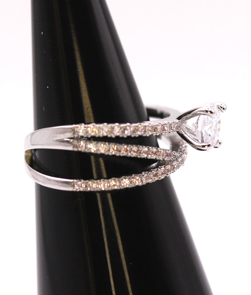 Women's Silver/Rhodium Plated Solitaire Ring with Clear Zircon Gemstones. The solitaire crystal is mounted on top of three crisscrossed rows of pave set zircon crystals. Side view