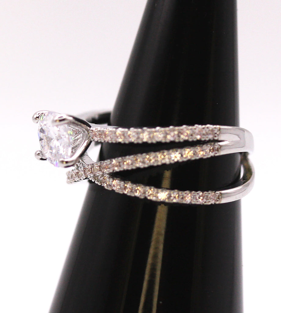 Women's Silver/Rhodium Plated Solitaire Ring with Clear Zircon Gemstones. The solitaire crystal is mounted on top of three crisscrossed rows of pave set zircon crystals. Side view