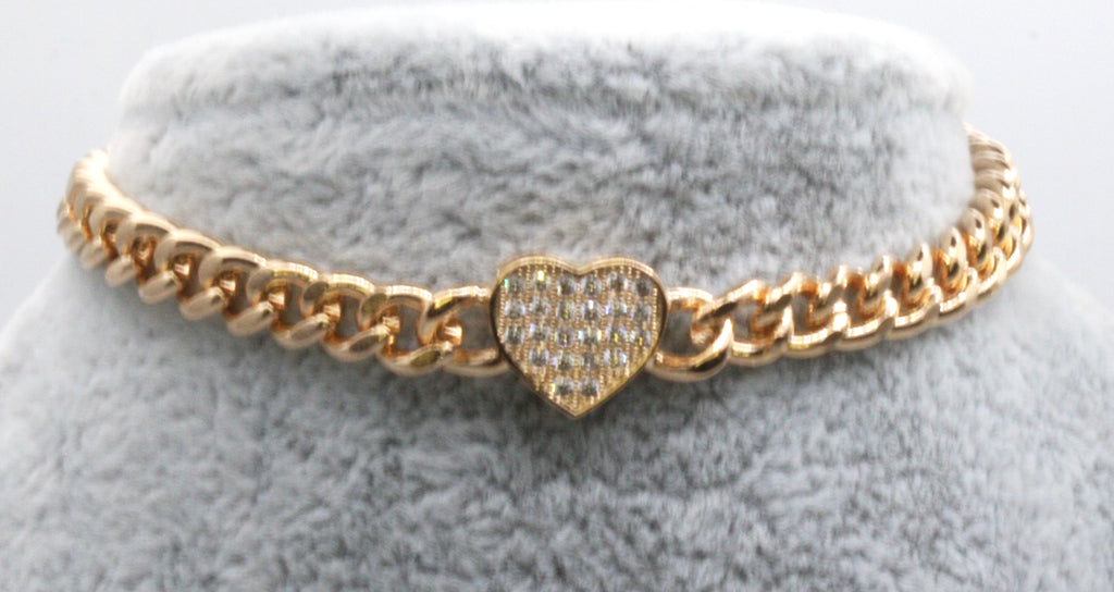 Elegant yet classic bracelet featuring a heart pave set with clear zircon gemstones. Yellow gold plated. Lobster claw closure.
