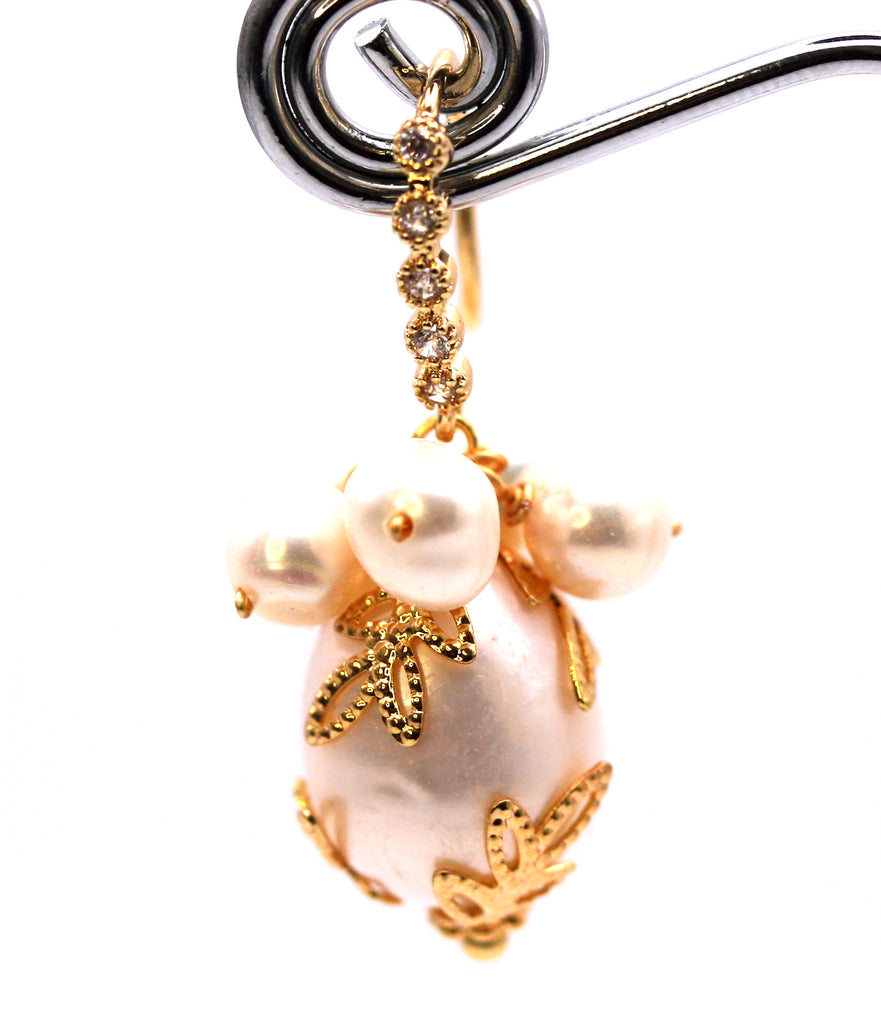 Women's Gold Plated Sterling Silver Earrings with Dangling 16 mm decorated Baroque freshwater Pearls. The white pearl hangs at the bottom of a Sheppard hook pave set with zircon gemstones and a cluster of five 4 mm white pearls. Front view