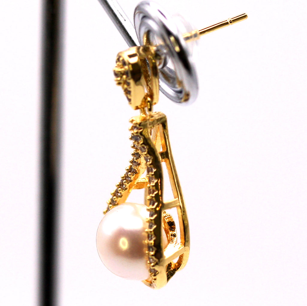 Women's Gold Plated Sterling Silver Earrings with freshwater Pearls. 8 mm white pearl in the centre of a tear drop ribbon pave set with clear zircon gemstones. Side view