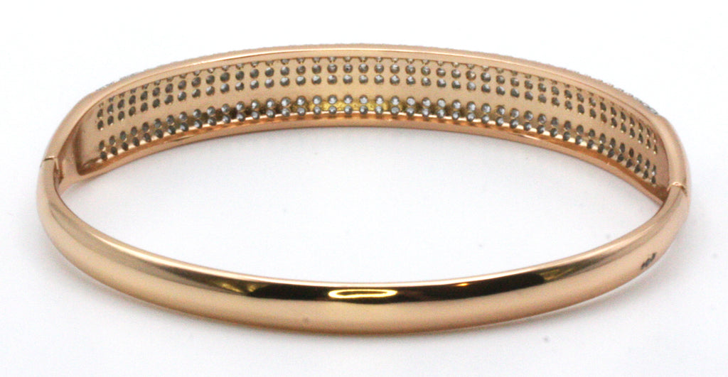 Women's bangle bracelet in rose gold plating featuring multi rows of pave set clear zircon gemstones