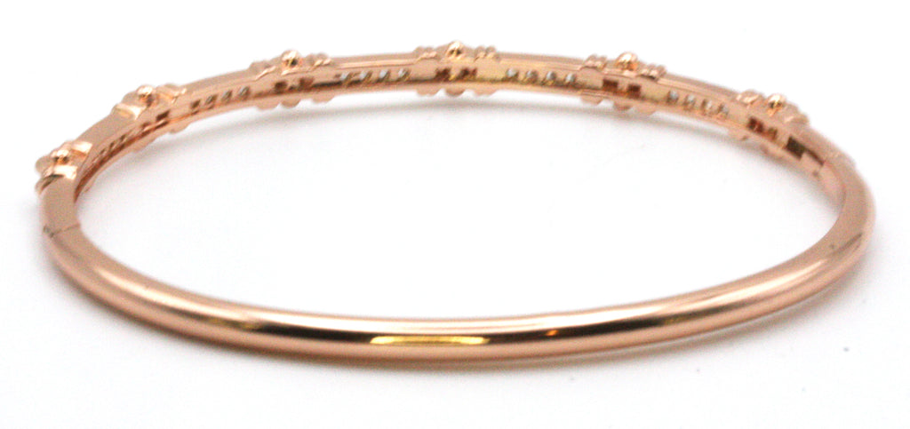 Women's bangle bracelet in Rose Gold plating. Featuring channel set clear zircon gemstones