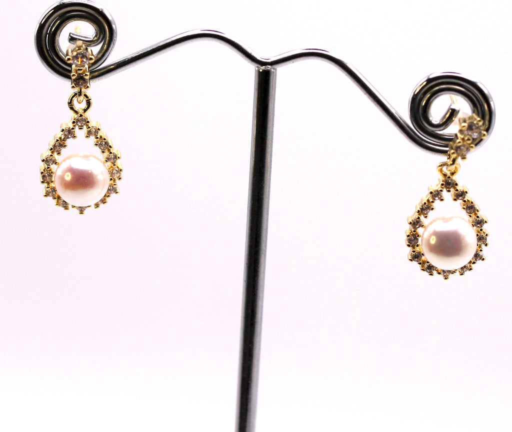 Women's Gold Plated Sterling Silver Dangling Earrings with freshwater Pearls.6 mm white pearl in a tear drop setting pave set with zircon gemstones.