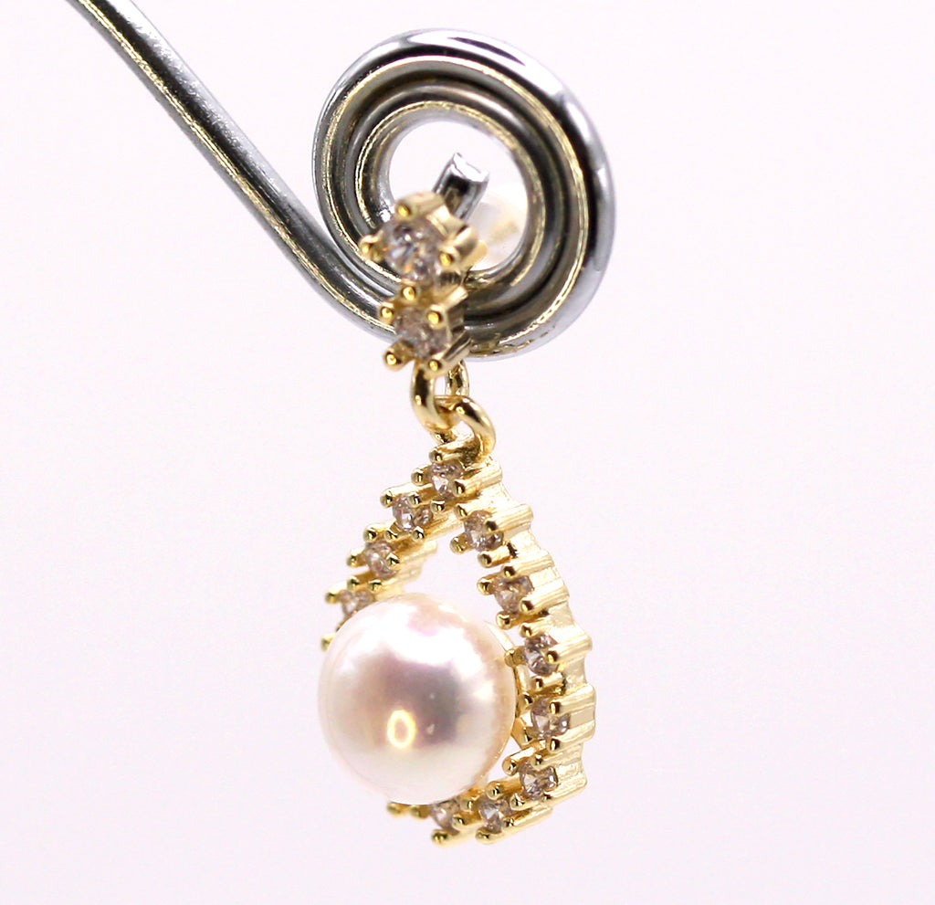 Women's Gold Plated Sterling Silver Dangling Earrings with freshwater Pearls. 6 mm white pearl in a tear drop pave set with zircon gemstones. Side view