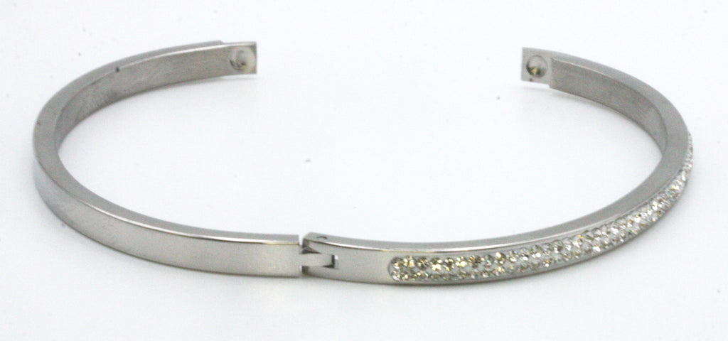 Women's bangle. This bracelet has a 7 1/4 inch diameter. With clear zircon gemstones.  available in yellow gold plating and silver/rhodium plating Open view