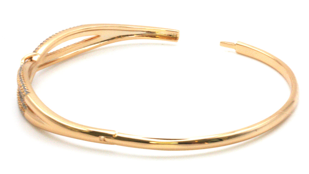 Women's bangle. This is an elegant bracelet in rose gold plating over stainless steel. The face shows a buckle design and is pave set with clear zircon gemstones. open view