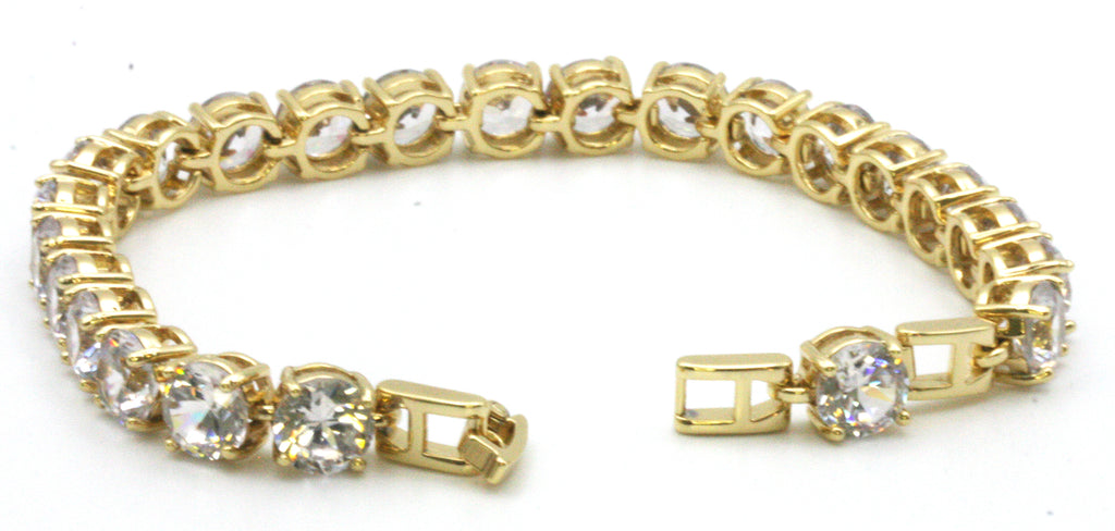 Women bracelet featuring 8 mm clear zircon gemstones. Seven-inch length with a 1/2-inch extension. Yellow gold plated. open view