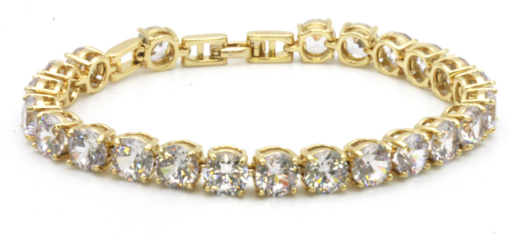 Women bracelet featuring 8 mm clear zircon gemstones. Seven-inch length with a 1/2-inch extension. Yellow gold plated.