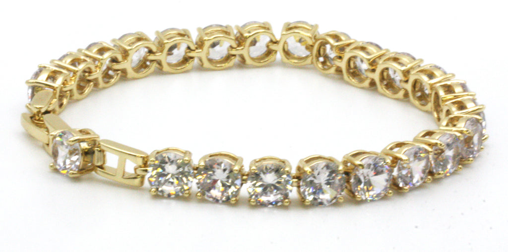 Women bracelet featuring 8 mm clear zircon gemstones. Seven-inch length with a 1/2-inch extension. Yellow gold plated. side view