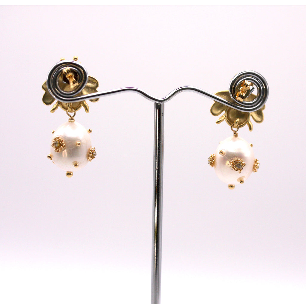Genuine freshwater pearl earrings.  The 12 mm diameter white pearl is decorated with clear zircon gemstones. The pearl dangles below a gold plated sterling silver bumble bee post. Back view