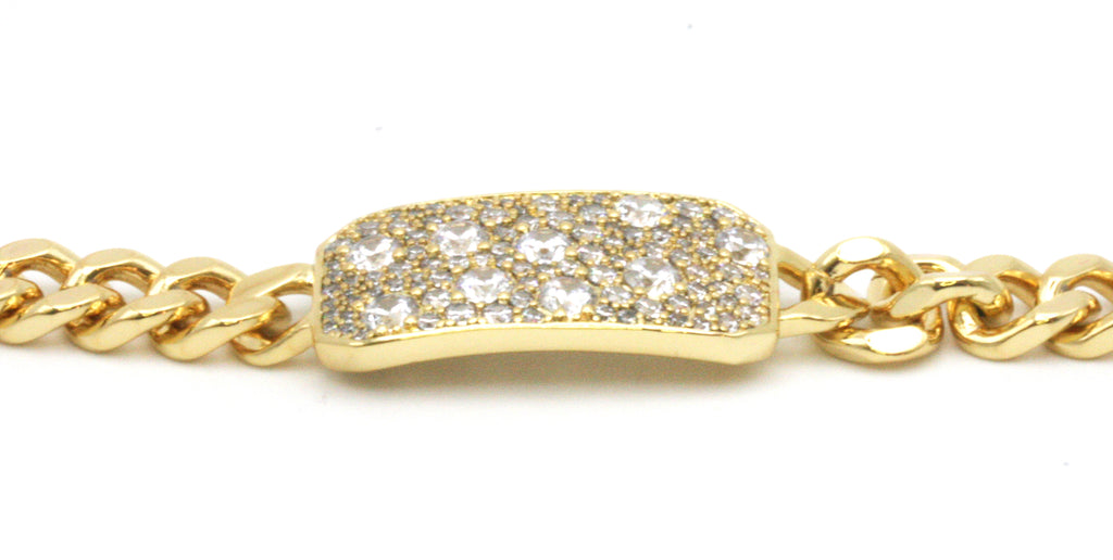 Women's bracelet. Yellow gold plated with a 1 1/4 inch by 1/2 inch ornament pave set with clear zircon gemstones. 7-inch length.