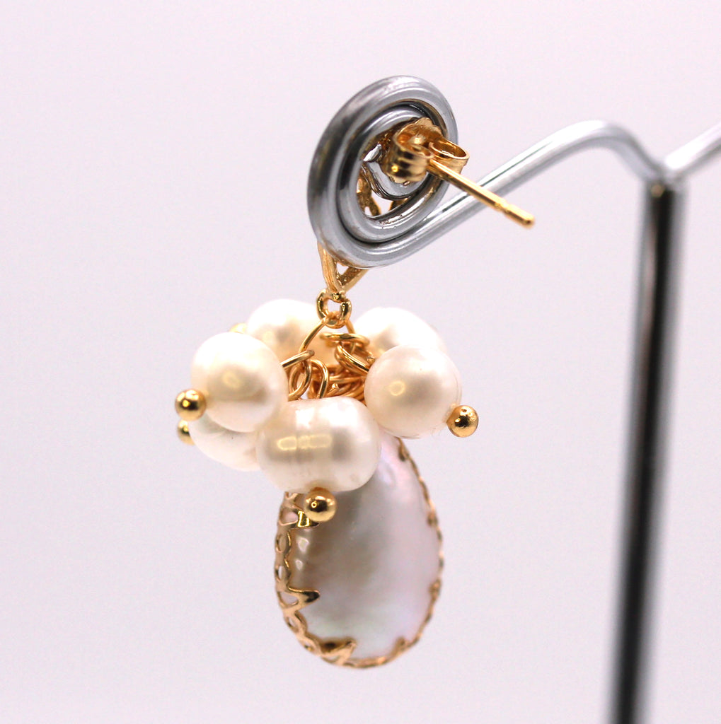 Genuine freshwater pearls. 14 mm teardrop baroque pearl with gold plated embellishments. Topped with a cluster of 4 mm white pearls. Gold plated sterling silver post. Back view