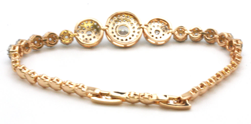 Women's bracelet rose gold plated featuring disks pave set with clear zircon gemstones. 7 inch length with a 1 inch extension. Back view