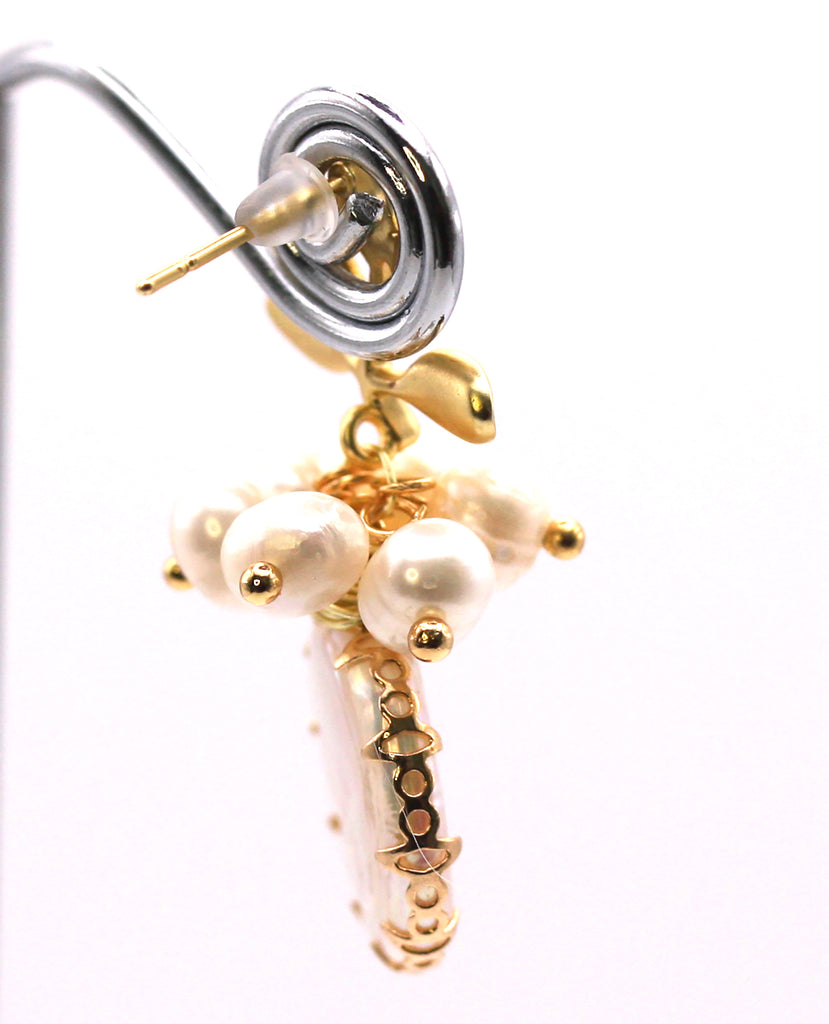 Women's Gold Plated Sterling Silver Earrings with Dangling 18 mm decorated Coin freshwater Pearls. The white pearl hangs at the bottom of a top post branch and leaves and a cluster of six 3 mm white pearls. Side view