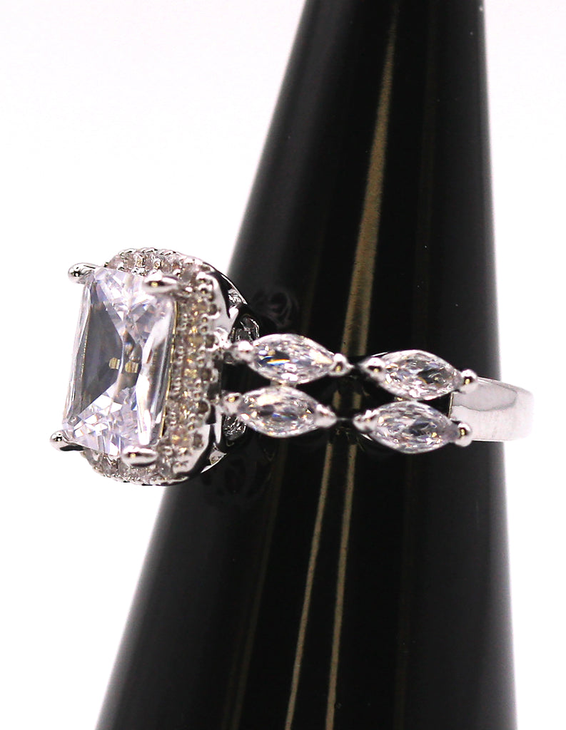 Women's Silver/Rhodium Plated Solitaire Ring with Clear Zircon Gemstones. The solitaire emerald cut zircon is accented with marquise cut and pave set crystals. Side view