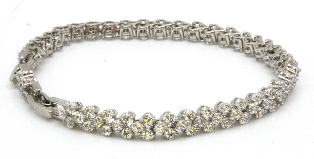 Women's bracelet. Stainless steel. Silver/Rhodium plated. With zircon gemstones. 6 3/4 length with a 1/2 inch extension. 6 mm wide.
