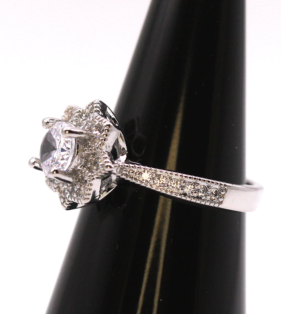 Women's Silver/Rhodium Plated Solitaire Ring with Clear Zircon Gemstones. The solitaire is accented with pave set crystal stones on the face of the ring and band. Side view