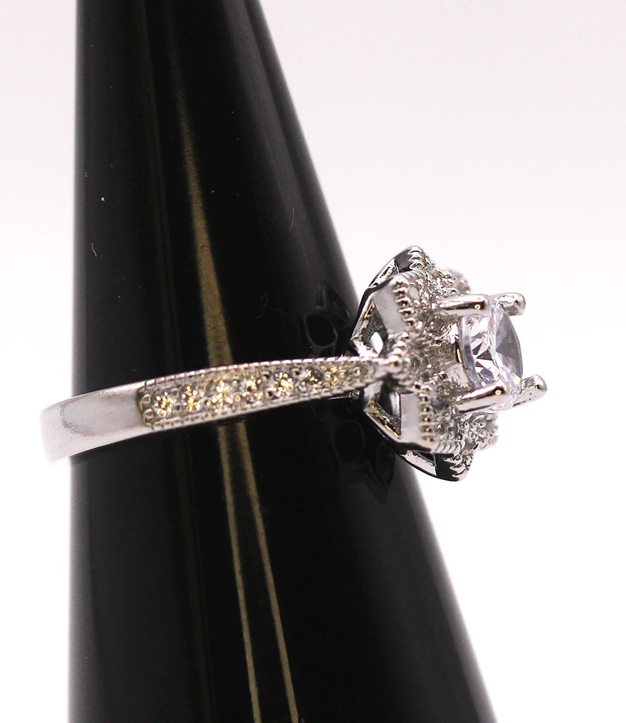 Women's Silver/Rhodium Plated Solitaire Ring with Clear Zircon Gemstones. The solitaire is accented with pave set crystal stones on the face of the ring and band. Side view