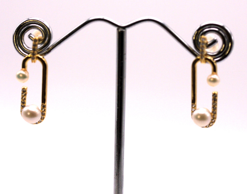 Women's Gold Plated Sterling Silver Earrings with two freshwater White Pearls.  A 4 mm pearl at the bottom of a dangling “paper clip” and a 2 mm pearl at the tip. The “paper clip” is pave set with zircon gemstones.