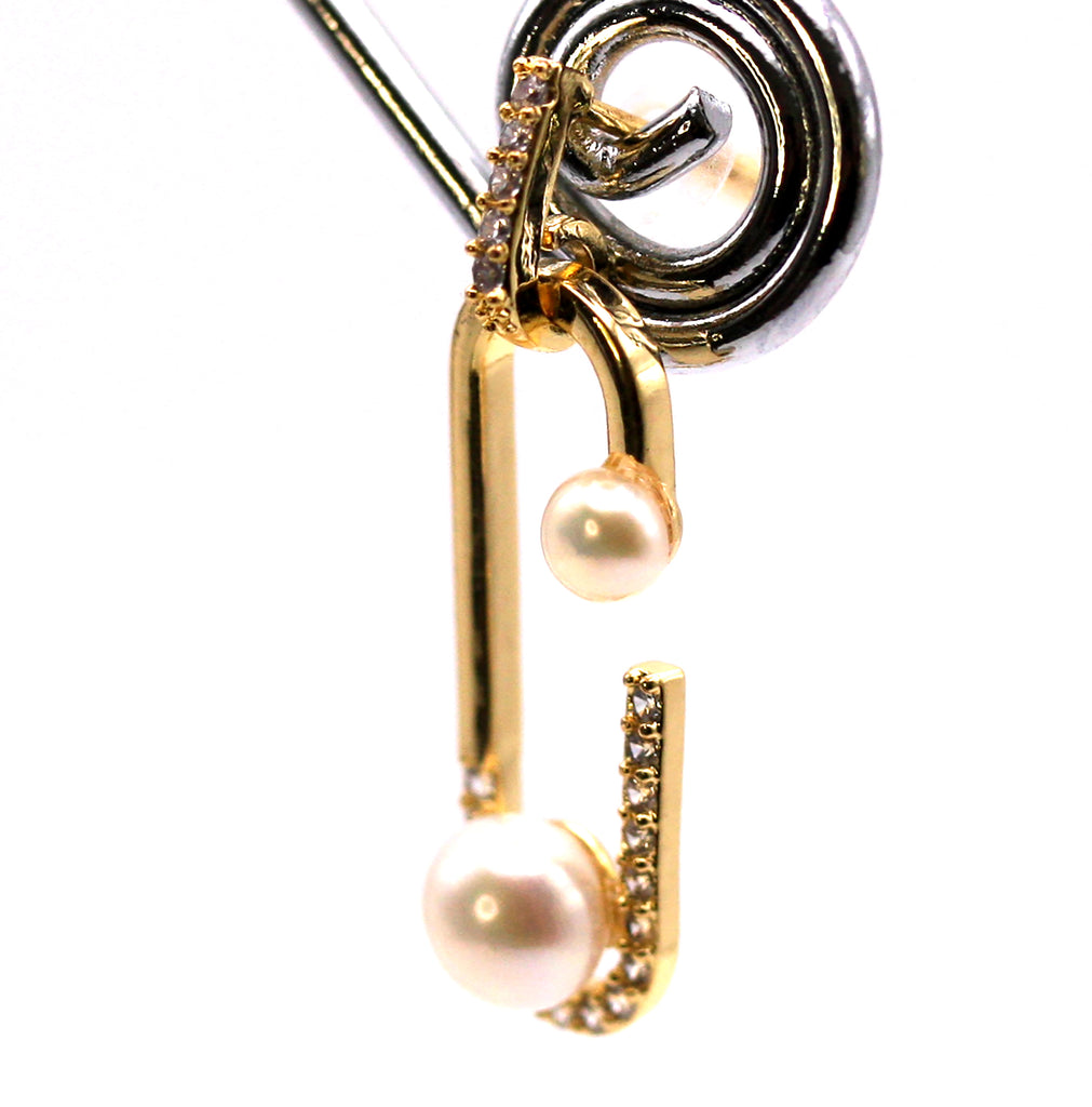 Women's Gold Plated Sterling Silver Earrings with two freshwater White Pearls.  A 4 mm pearl at the bottom of a dangling “paper clip” and a 2 mm pearl at the tip. The “paper clip” is pave set with zircon gemstones. Side view