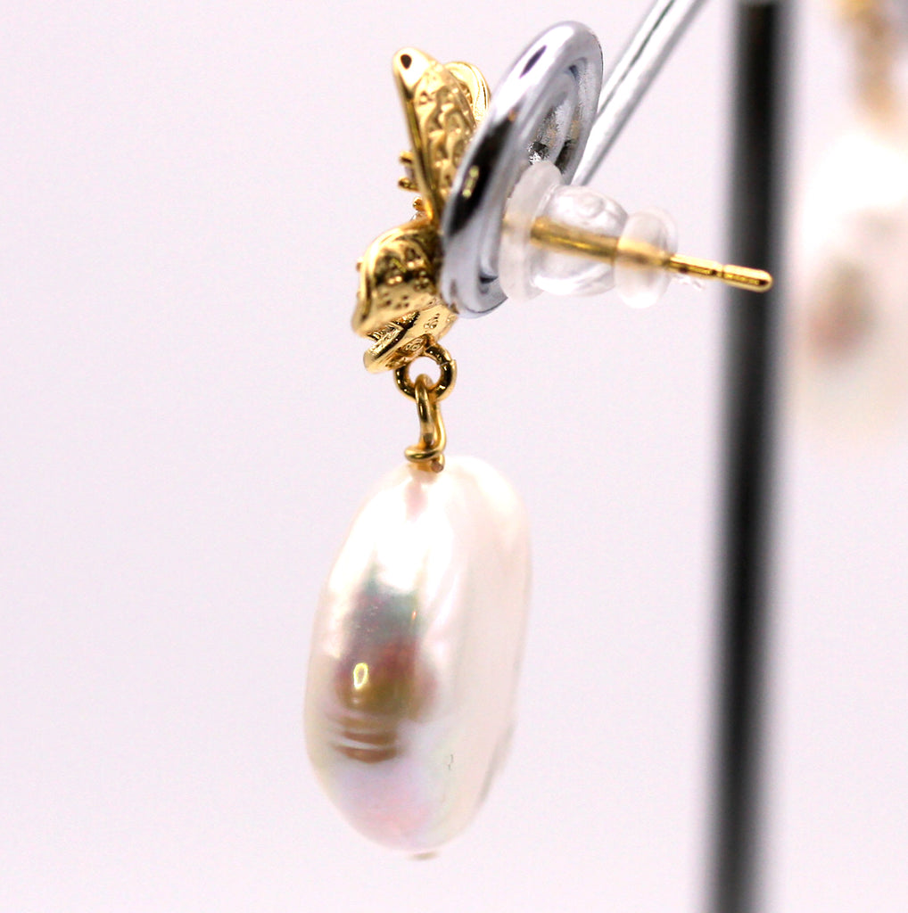 Women's Gold Plated Sterling Silver Earrings with Coin freshwater Pearls.  12 mm white coin pearl with a nice luster and smooth surface dangling below a flower pave set with five clear zircon gemstones. Top post. Side view