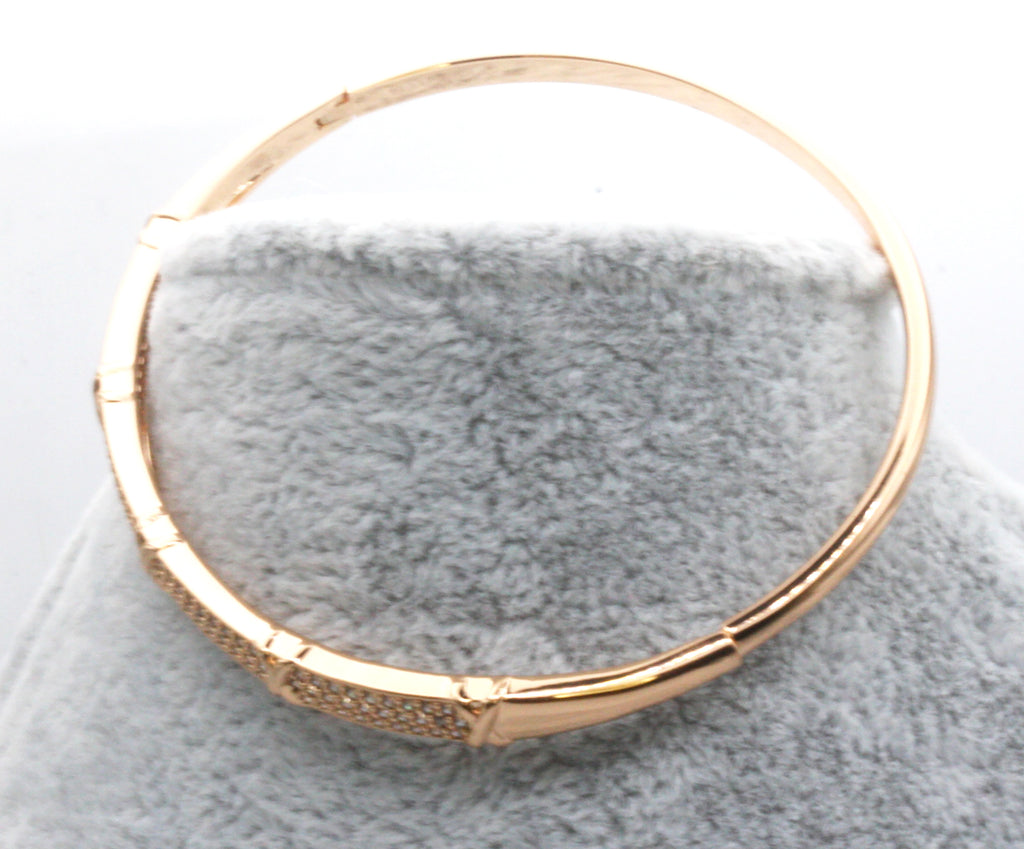 Women's bangle bracelet in Rose Gold plating and pave set clear zircon gemstones