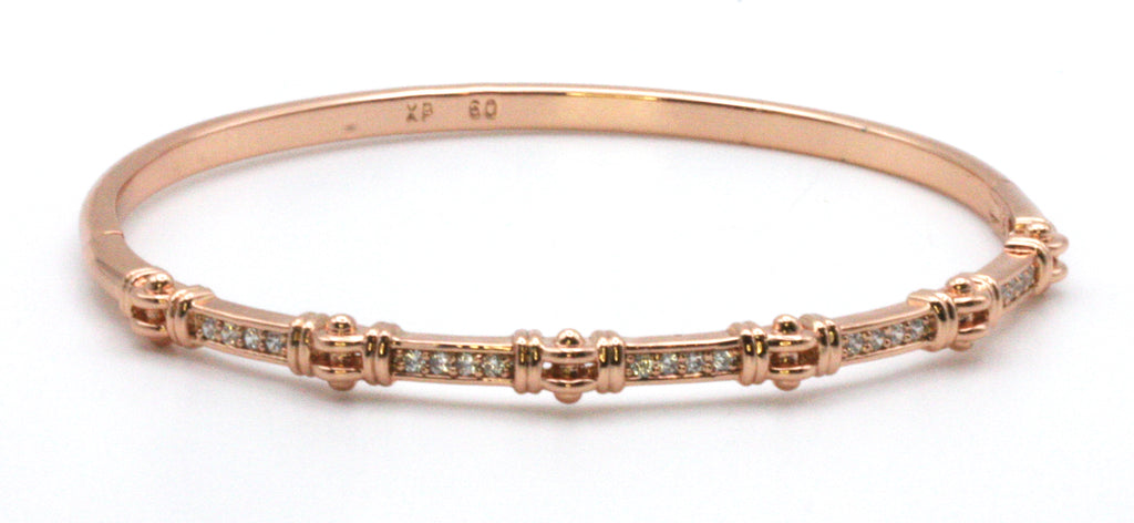 Women's bangle bracelet in Rose Gold plating. Featuring channel set clear zircon gemstones